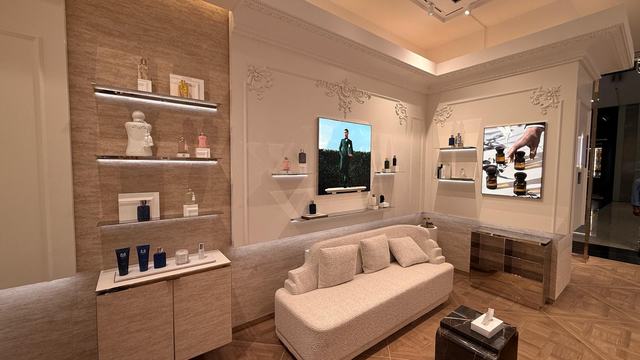 Boutique interior with panelled walls, shelving and seating in Bahrain