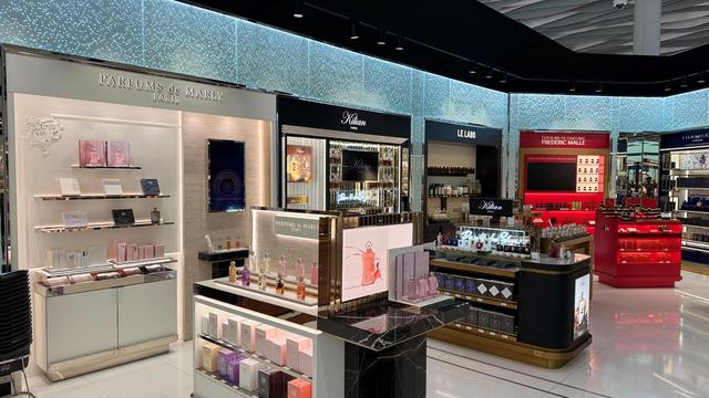 Shop-in-shop retail wall units under a lit ceiling, installed in Bahrain